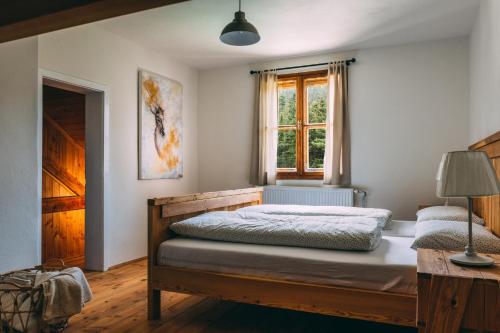 a bedroom with a bed and a window at Villa Šumik- Peaceful Hideaway in Ruše
