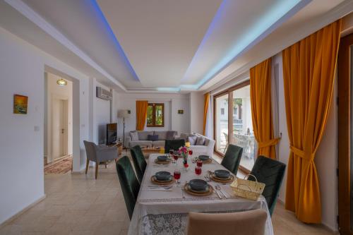 a living room with a long table and chairs at Infinity Olympia Villas in Oludeniz
