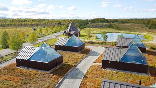 an overhead view of a building with blue roofs and a lake at Aurora Pyramid Glass Igloos in Köngäs
