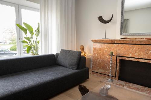 a living room with a couch and a fireplace at #MacLeod2 in Ostend