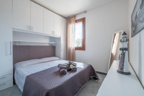 a bedroom with a bed with a purse on it at CASTELSARDO- Elegante Appartamento vista Mare in Castelsardo