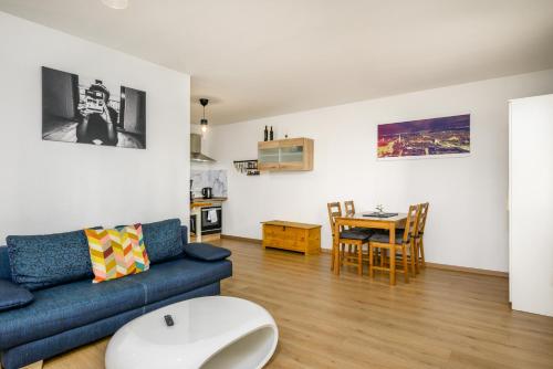a living room with a couch and a table at Arbio I Spacious Apart near Auensee in Leipzig