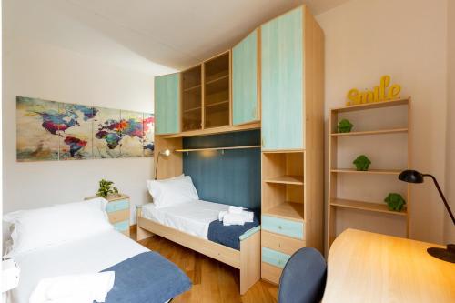 a bedroom with two beds and a book shelf at Piazza delle Vettovaglie Historic Center Eco Flat in Pisa