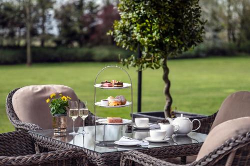a table with a plate of food on it at Woodlands Park Hotel in Cobham