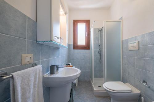 a bathroom with a sink and a toilet and a shower at CASTELSARDO- Elegante Appartamento vista Mare in Castelsardo