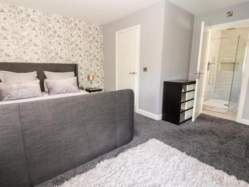 a bedroom with a large bed and a window at Nant House in Wrexham