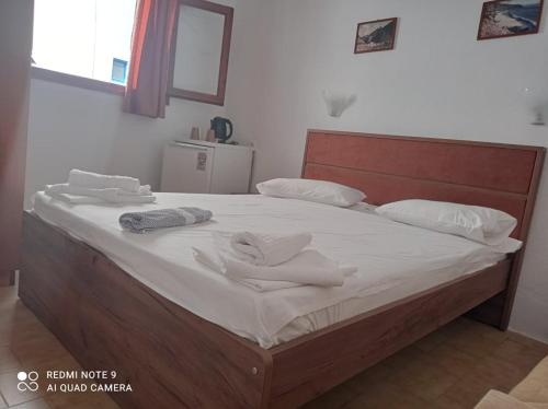 a large bed with white sheets and towels on it at Faragi in Agia Roumeli