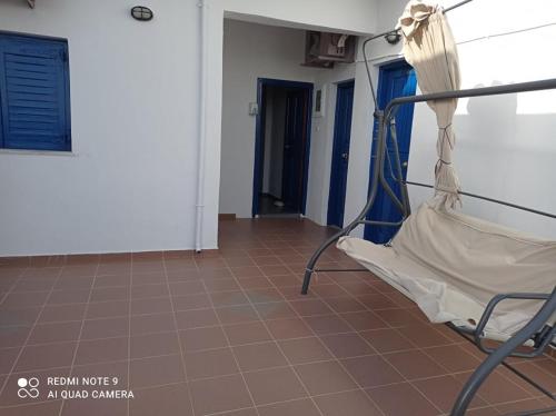 a hospital room with a bed and a tiled floor at Faragi in Agia Roumeli