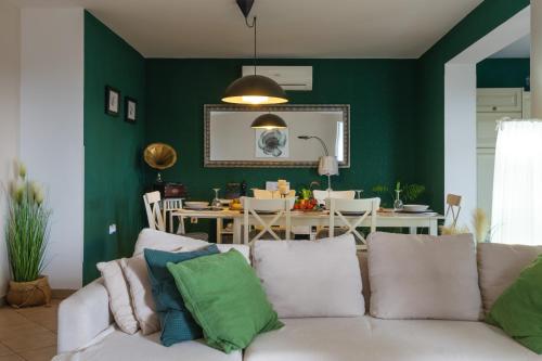 a living room with green walls and a white couch at Villa Laura in Krnica