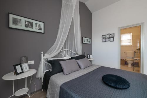 a bedroom with a bed with a blue comforter at Villa Laura in Krnica