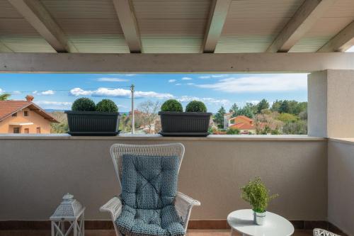 a view from the balcony of a house with two chairs at Villa Laura in Krnica