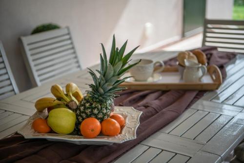 a tray of fruit on a table with a plate of fruit at Villa Laura in Krnica