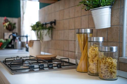a kitchen counter with two jars of pasta on a stove at Villa Laura in Krnica
