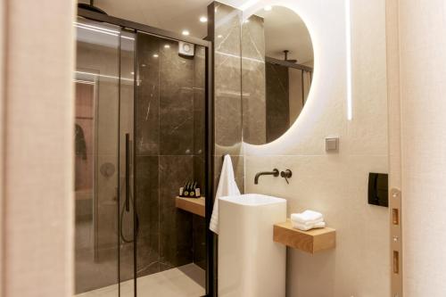 a bathroom with a shower and a sink and a mirror at Sea & the City in Thessaloniki