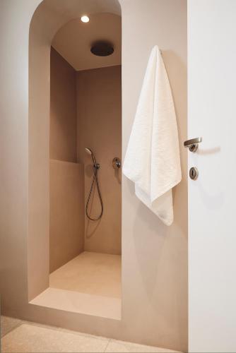 a bathroom with a shower with a white towel at Kanala Studios in Kithnos