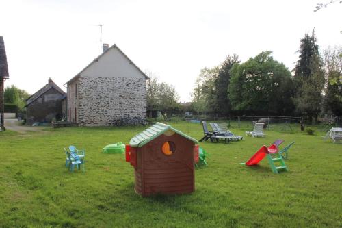 a group of playground equipment in a grass field at La lavandiere in La Chapelle-au-Riboul