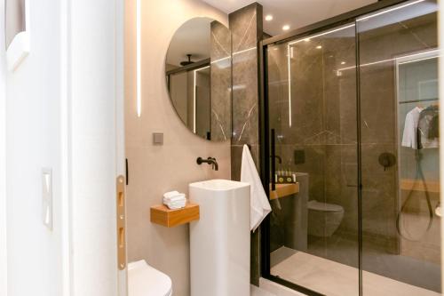 a bathroom with a sink and a shower at Sea & the City in Thessaloniki