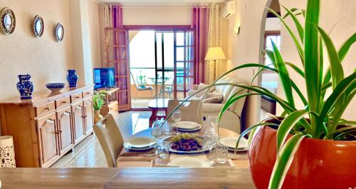 a living room with a table with a potted plant at Beautiful apartment near LaMata Beach with PANORAMA SEA view!!! in Torrevieja