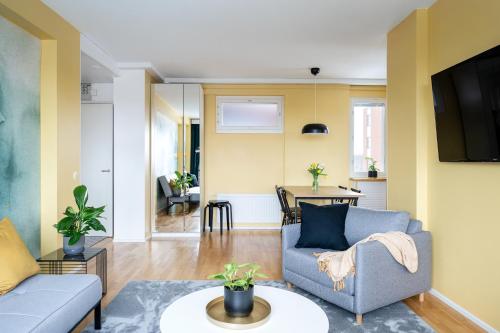 a living room with a couch and a table at 2 Bedroom apartment with free parking in Kuopio