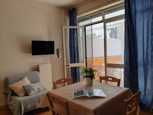 a room with a table with a book on it at Residence Le Barchette in San Cataldo