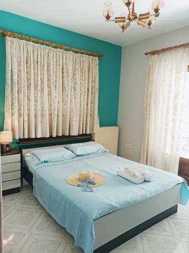 a bedroom with a bed with a hat on it at Sunny Loft in Kavála