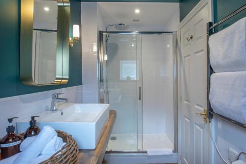 a bathroom with a shower and a sink and a shower at The Bath Hotel in Lynmouth