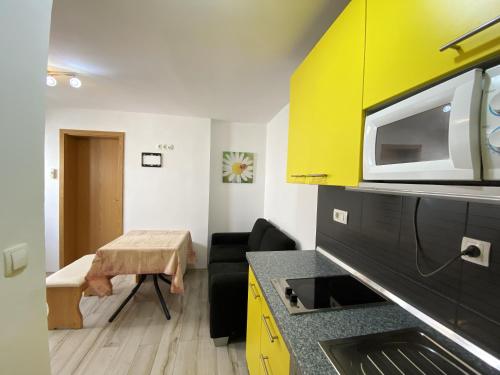 a small room with a kitchen with a yellow cabinet at Elegant Apartment in Vodice - 53 m² - Near the Sea in Vodice