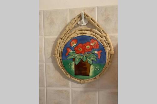 a mirror hanging on a bathroom wall with a plant at La Terrazza sulle Apuane in Fivizzano