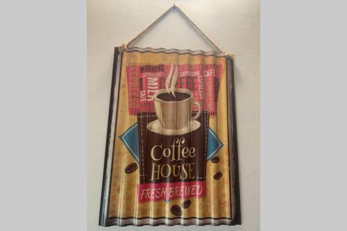 a coffee house sign hanging on a wall at La Terrazza sulle Apuane in Fivizzano