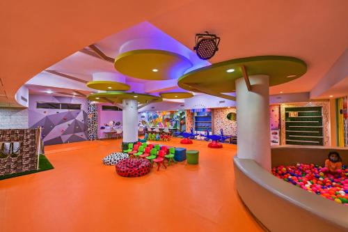 a living room filled with lots of colorful decorations at Fariyas Resort Lonavala in Lonavala
