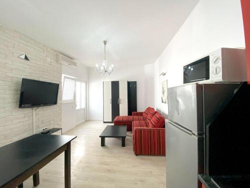 a living room with a refrigerator and a red couch at Seaview Apartment in Vodice - 47m² in Vodice