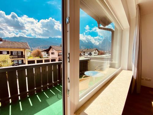 a room with a large window with a view of a balcony at Ferienhaus Butterfly 2 in Garmisch-Partenkirchen