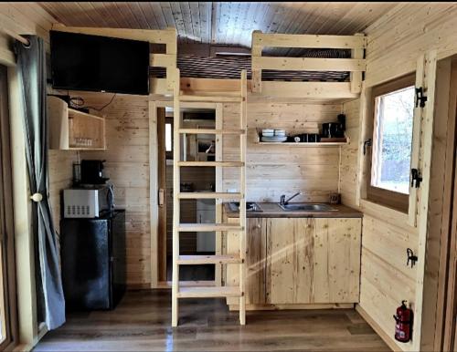 a kitchen with a bunk bed and a sink at Tiny-river in Falaën