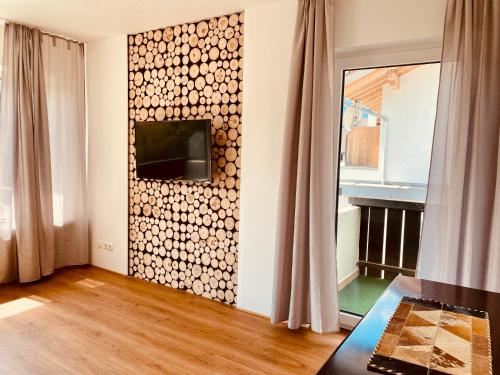 a living room with a wall covered in logs at Ferienhaus Butterfly 2 in Garmisch-Partenkirchen