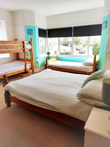 a bedroom with two beds and a window at St Breca in Newquay
