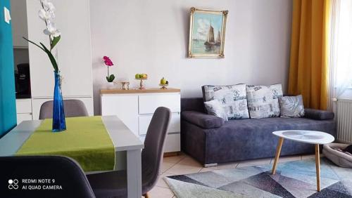 a living room with a couch and a table at Marina Apartments in Kołobrzeg