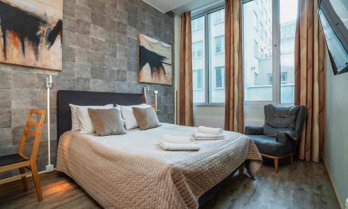 a bedroom with a bed, chair and a window at Thon Partner Hotel Kungsbron in Stockholm