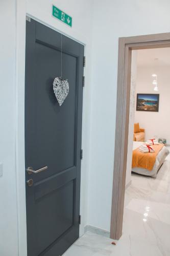 a door with a heart on it in a bedroom at QLiving Central New Apartments Gzira Sliema Promenade in Il-Gżira