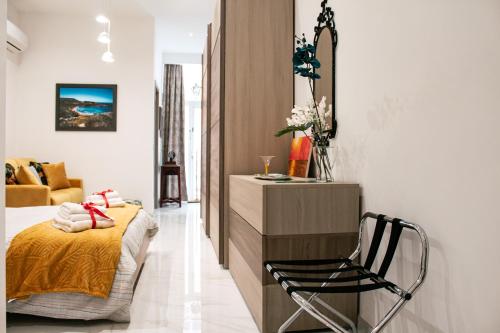 a bedroom with a bed and a chair in it at QLiving Central New Apartments Gzira Sliema Promenade in Il-Gżira