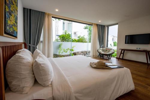 a bedroom with a white bed with a large window at Ocean View Luxury Retreat - Private Villa by Nest Group in Nha Trang