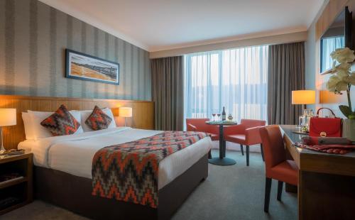 a hotel room with a bed and a desk at The Fitzwilton Hotel in Waterford