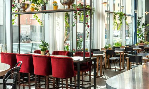 a restaurant with tables and chairs in it at Thon Partner Hotel Kungsbron in Stockholm