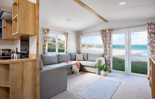 a living room with a couch and a view of the ocean at The Lakes Rookley in Rookley