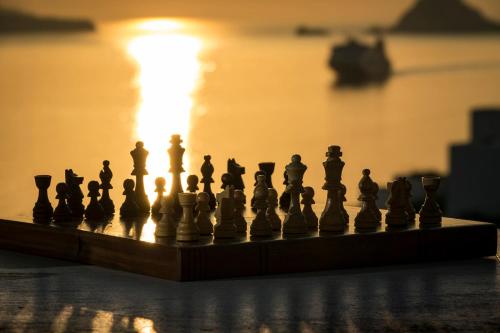 a chess board with the sun in the background at Villa Mikros Vorias in Karavostasi