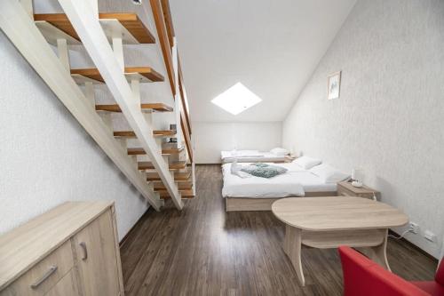 a bedroom with two beds and a staircase at Hotel Fit Fun in Harrachov