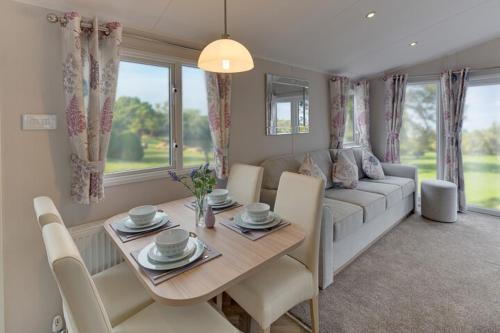 a living room with a table and a couch at The Lakes Rookley in Rookley