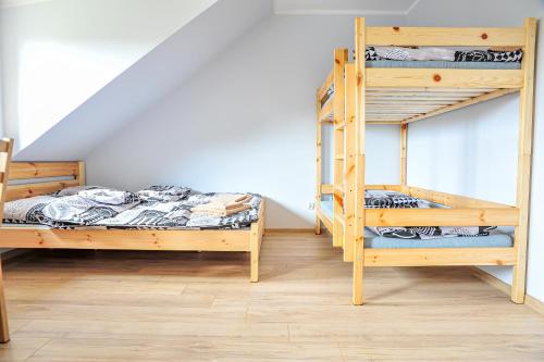 a bedroom with two bunk beds and a staircase at Farma Serock in Serock