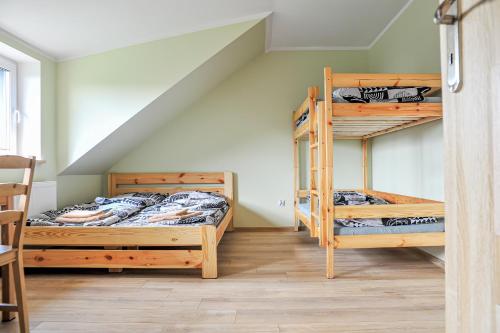 two bunk beds in a room with a staircase at Farma Serock in Serock