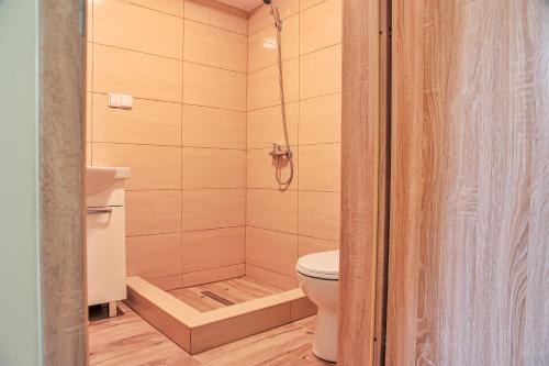 a bathroom with a toilet and a shower at Farma Serock in Serock