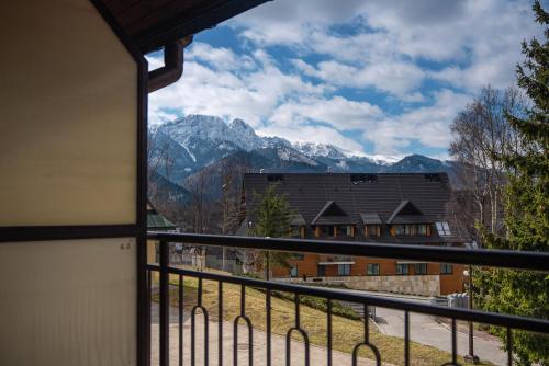a view from a balcony of a house with mountains at Kompleks Antałówka Termy & Med in Zakopane